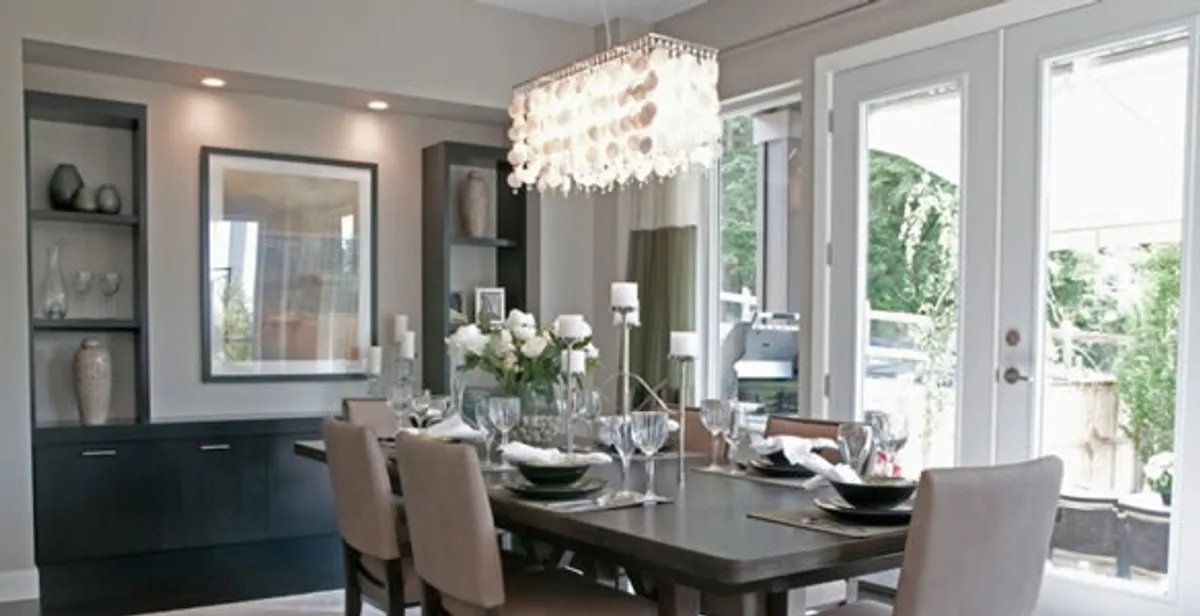 Elegant dining room chandelier installation above table in Orange, CA