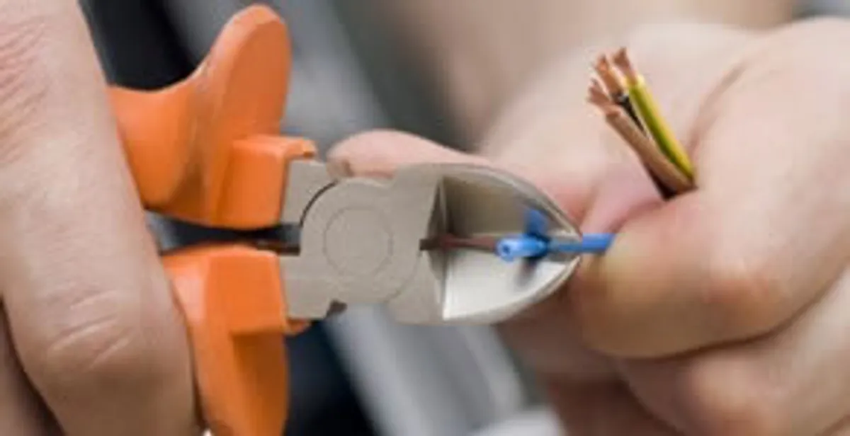 professional electrical services showing precise wire cutting by licensed electricians in Orange, CA